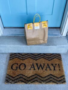 Funny Doormat at Front Door Funny doormat with the words “Go Away” placed at a front door entrance